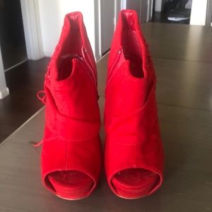 A pair of red faux suede heels